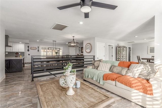 4410 E Boston Ave, Las Vegas, NV 89104 - living room featuring ceiling fan with notable chandelier
