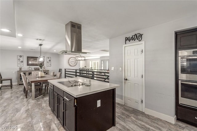 4410 E Boston Ave, Las Vegas, NV 89104 - kitchen with double oven, a center island, black electric stovetop, island range hood, and decorative light fixtures