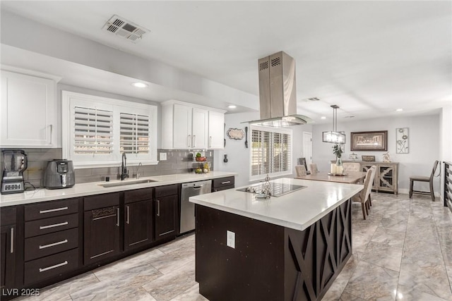 4410 E Boston Ave, Las Vegas, NV 89104 - kitchen featuring dishwasher, sink, island exhaust hood, a center island, and black electric stovetop