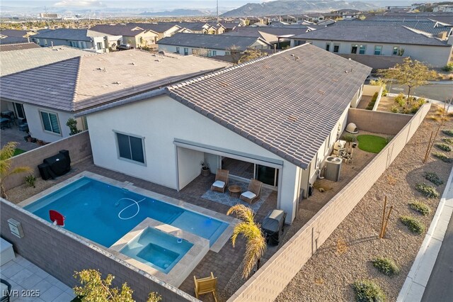 view of pool with a patio area and an in ground hot tub