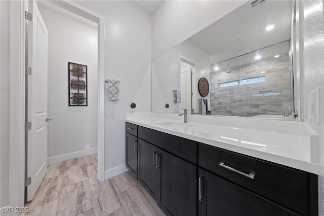 bathroom featuring vanity and a shower with shower door