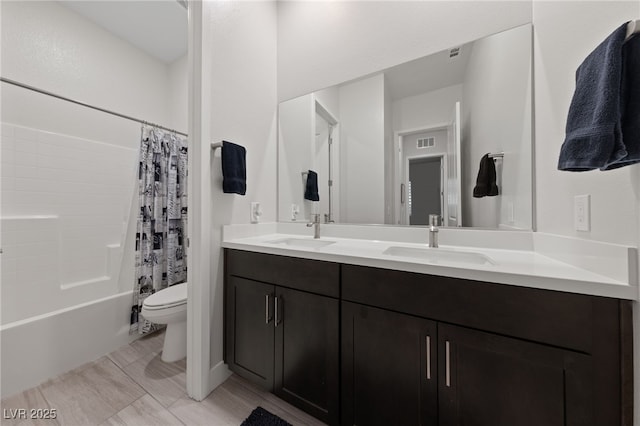 full bathroom featuring toilet, vanity, and shower / bath combo with shower curtain