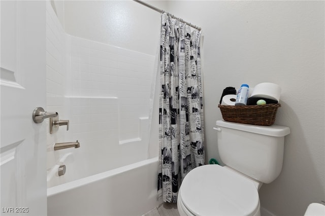 bathroom featuring shower / tub combo with curtain and toilet