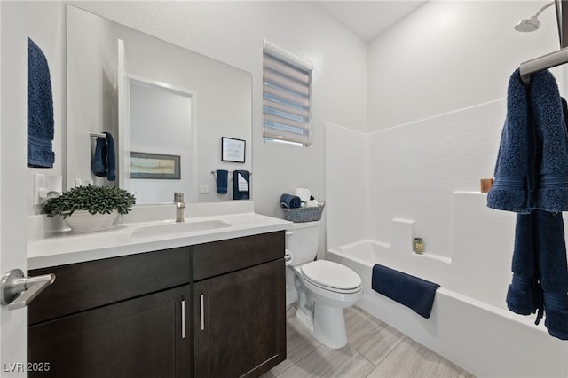 full bathroom featuring vanity, bathtub / shower combination, and toilet