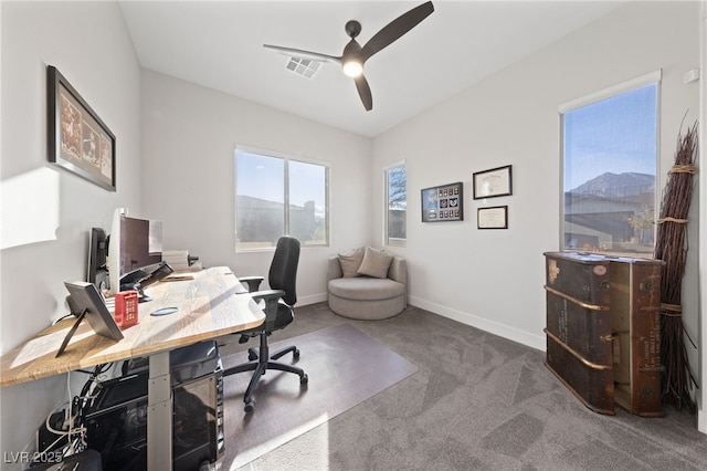 office space with ceiling fan and carpet