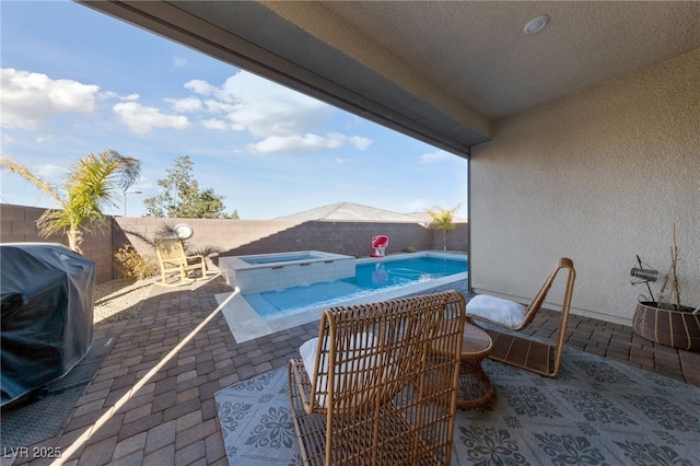 view of swimming pool featuring an in ground hot tub, a grill, and a patio