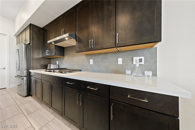 kitchen featuring tasteful backsplash, dark brown cabinetry, and stainless steel appliances