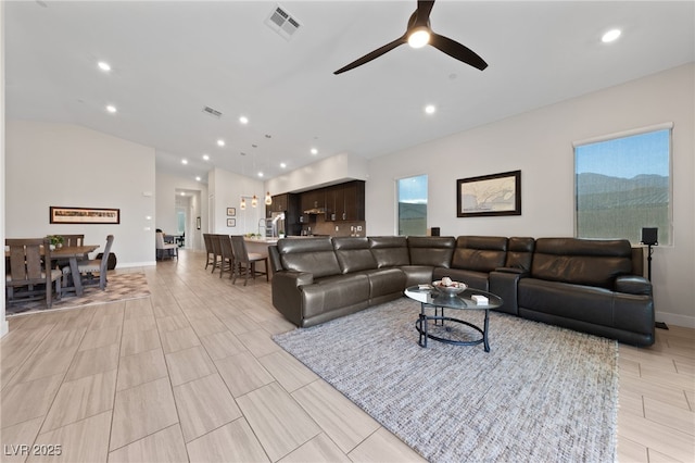 living room with vaulted ceiling and ceiling fan