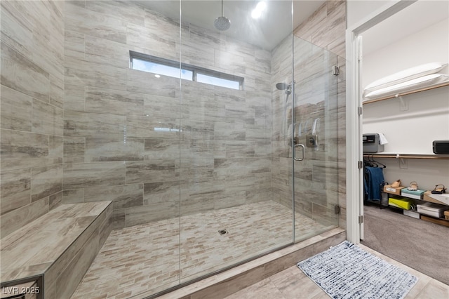 bathroom featuring a shower with door