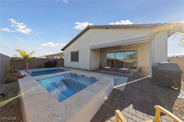 view of pool featuring an in ground hot tub, area for grilling, and a patio area