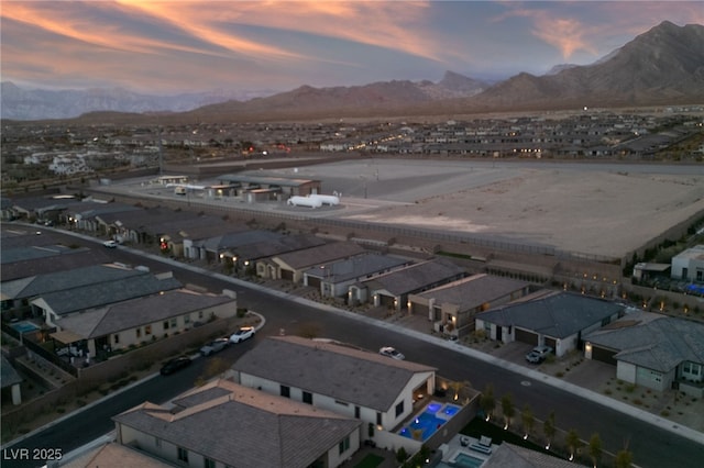 aerial view at dusk featuring a mountain view