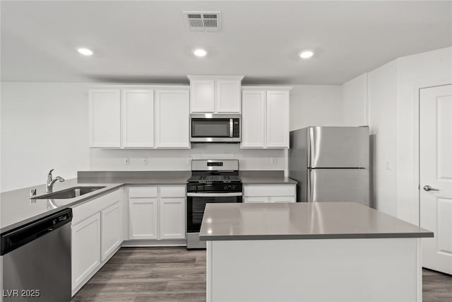 kitchen featuring sink, dark hardwood / wood-style floors, white cabinets, and appliances with stainless steel finishes