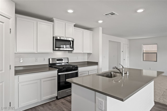 kitchen featuring stainless steel appliances, a kitchen island with sink, sink, and white cabinets