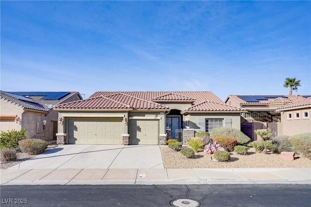 view of front of property with a garage, concrete driveway, solar panels, a tiled roof, and stucco siding