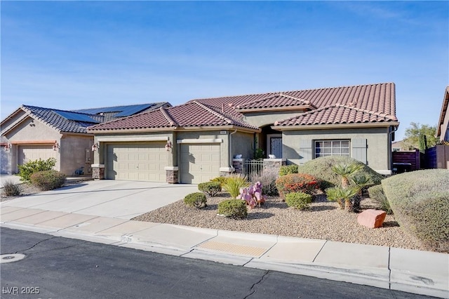 view of front of house featuring a garage, concrete driveway, solar panels, and stucco siding