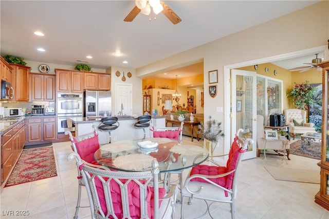 dining space with a ceiling fan, recessed lighting, and light tile patterned flooring