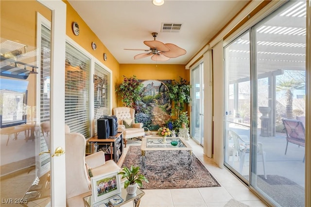 sunroom / solarium with ceiling fan and visible vents