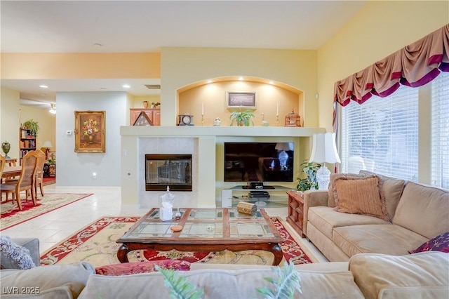 living area with light tile patterned floors, a fireplace, and recessed lighting