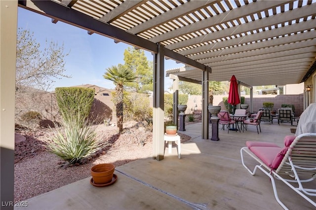 view of patio featuring outdoor dining space, a fenced backyard, and a pergola