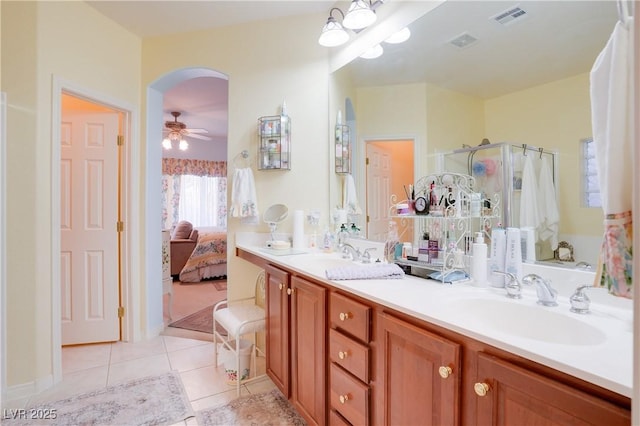 bathroom with a sink, tile patterned flooring, visible vents, and connected bathroom