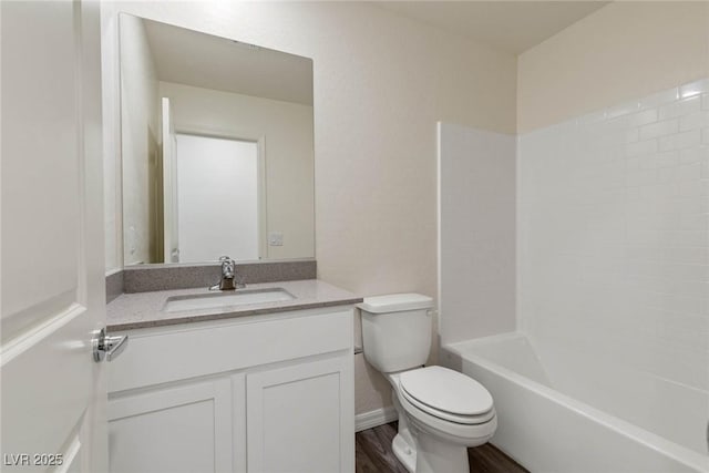 full bathroom featuring hardwood / wood-style flooring, vanity, shower / bath combination, and toilet