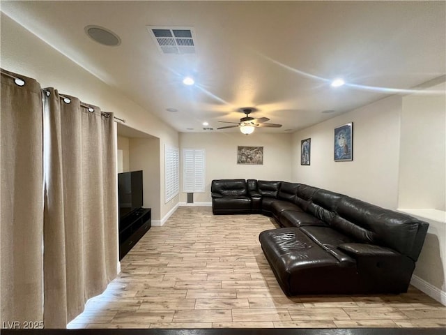 living room with ceiling fan and light hardwood / wood-style flooring