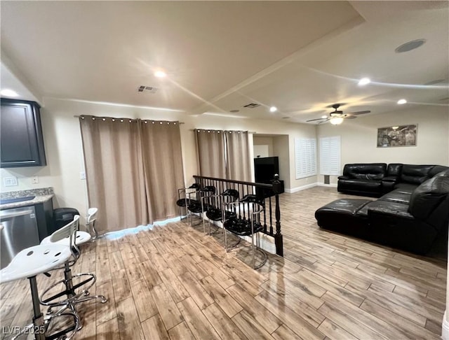 living room featuring light hardwood / wood-style floors and ceiling fan