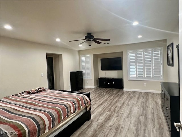 bedroom with ceiling fan and light hardwood / wood-style floors