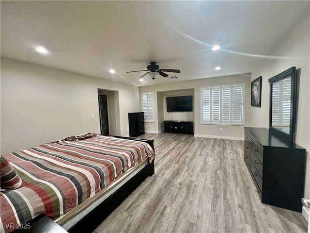 bedroom with ceiling fan and light hardwood / wood-style flooring