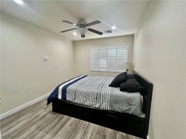 bedroom featuring light hardwood / wood-style flooring and ceiling fan