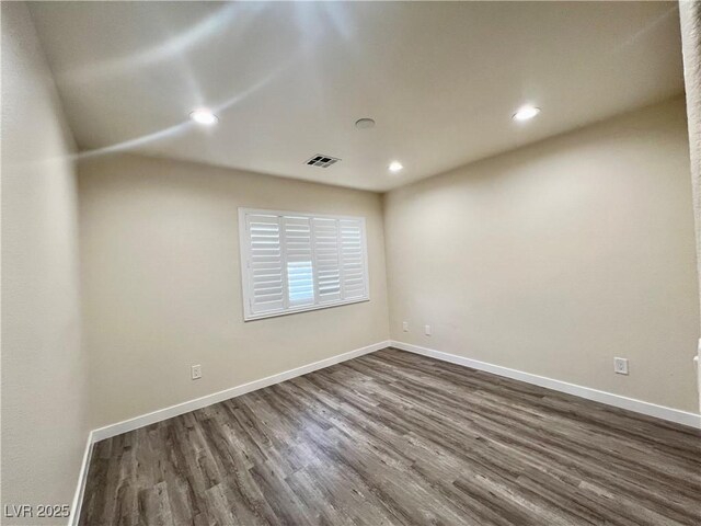10618 Timber Stand St, Las Vegas, NV 89183 - empty room with baseboards, dark wood-style flooring, recessed lighting, and visible vents