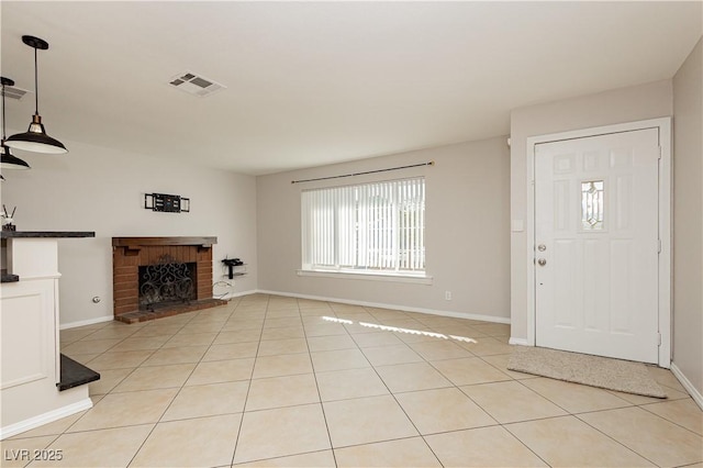 entryway featuring light tile patterned floors and a fireplace