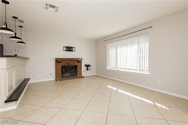 unfurnished living room featuring a fireplace and light tile patterned floors