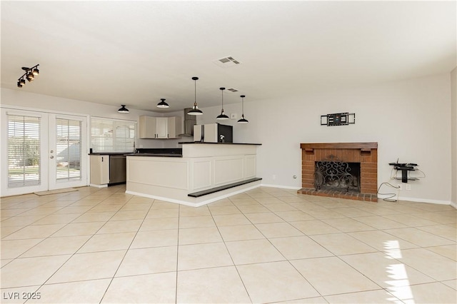 unfurnished living room with a fireplace and light tile patterned floors