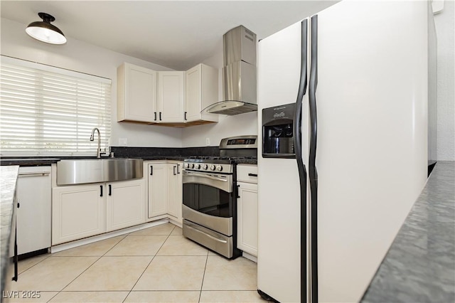 kitchen featuring sink, fridge with ice dispenser, gas stove, white cabinets, and wall chimney exhaust hood