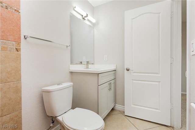 bathroom featuring vanity, toilet, and tile patterned flooring