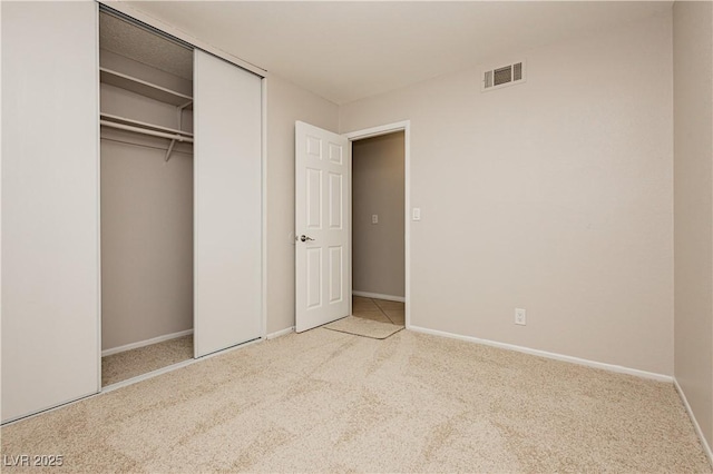 unfurnished bedroom featuring a closet and carpet