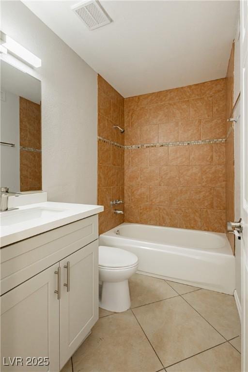 full bathroom with vanity, tile patterned floors, toilet, and tiled shower / bath