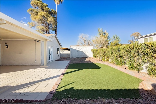 view of yard featuring a patio area, french doors, and a storage unit