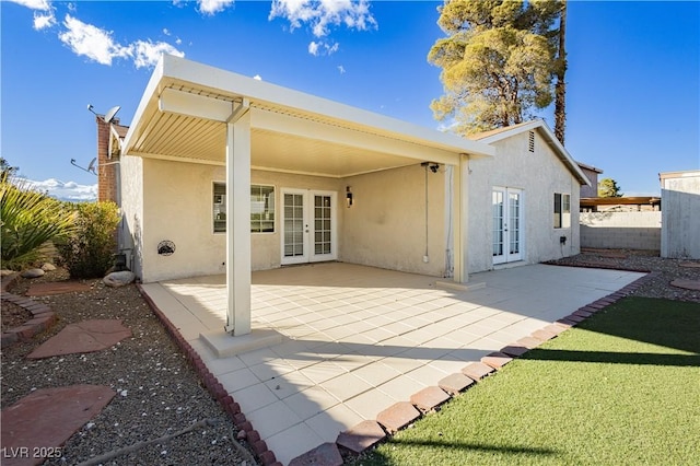 back of house with french doors and a patio