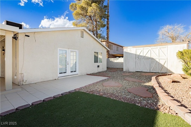 back of house featuring a patio and french doors