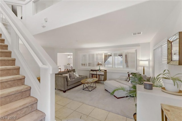 living room with a notable chandelier and light tile patterned floors