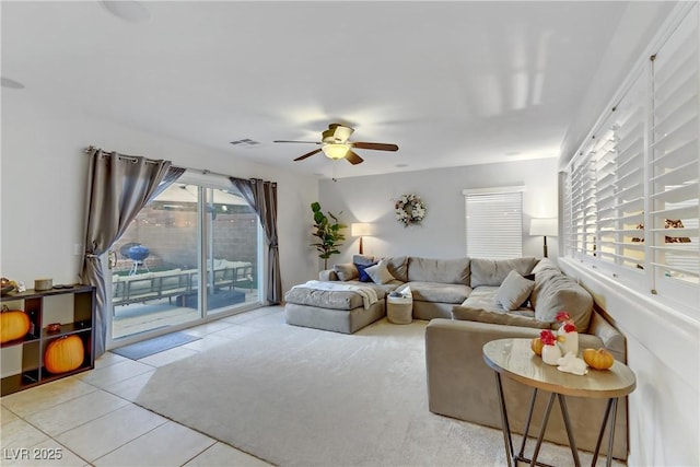 tiled living room featuring ceiling fan