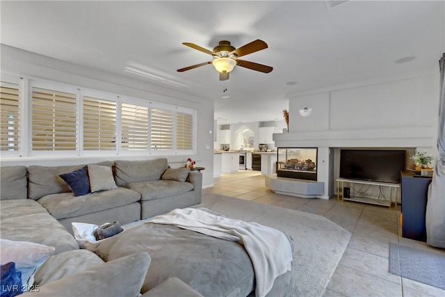 tiled living room featuring ceiling fan