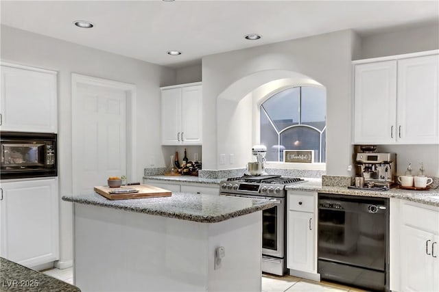 kitchen with a kitchen island, light stone countertops, black appliances, white cabinets, and light tile patterned flooring