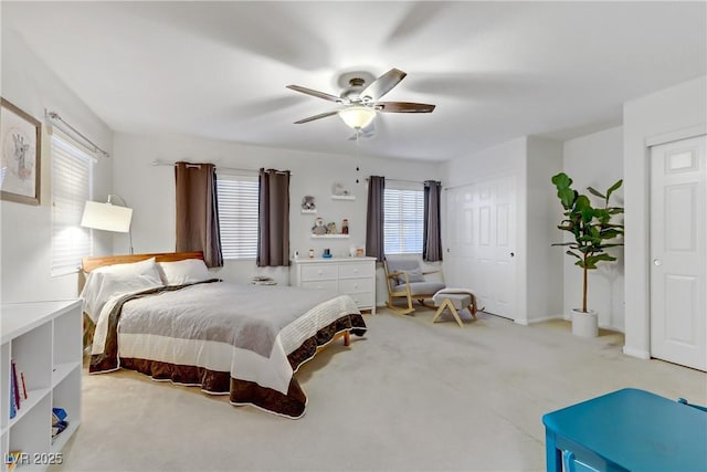 bedroom featuring light colored carpet and ceiling fan