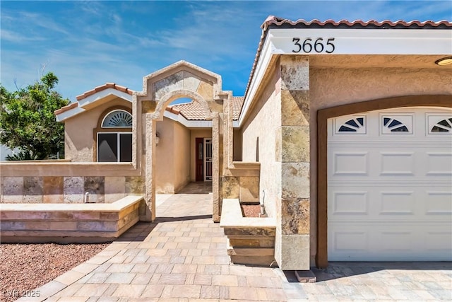 view of front of home with stucco siding and a tiled roof