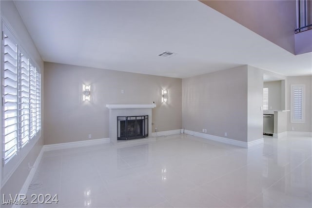 unfurnished living room featuring light tile patterned flooring