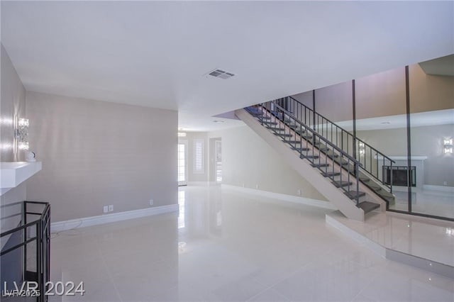 unfurnished living room featuring light tile patterned flooring