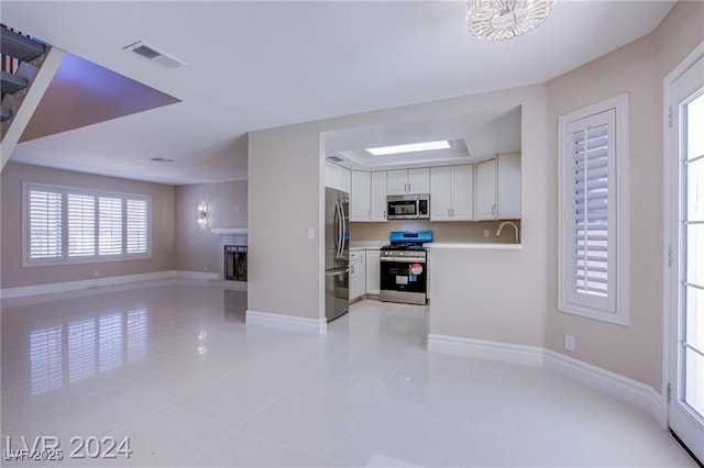 kitchen with white cabinetry, light tile patterned floors, sink, and appliances with stainless steel finishes